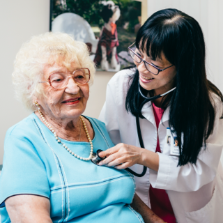 Doctor using a stethoscope on a woman's chest