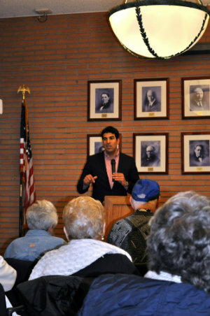 Man talking in front of elderly people