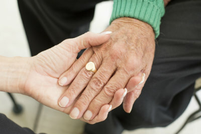 Old couple holding hands