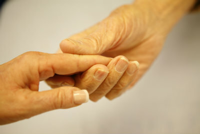 Two elderly holding hands