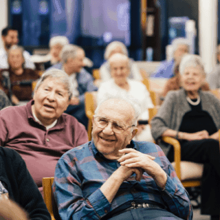 A group of people sitting in an audience