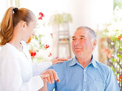 Elderly man holding a woman's hands