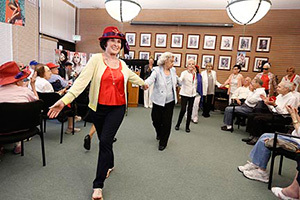 Elderly dancing with red hat