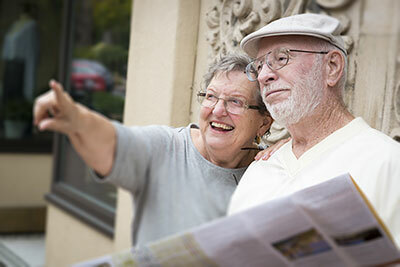 Old couple looking at nowhere while holding a news paper