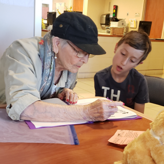 Woman helping a young boy with homework