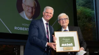 Robert Hirsch accepts Reflections Award from CEO and President Dale Surowitz
