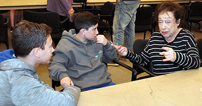 Group of young people listening to an old woman