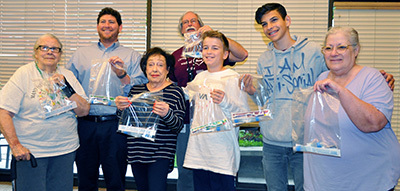 Group of people holding a plastic bag