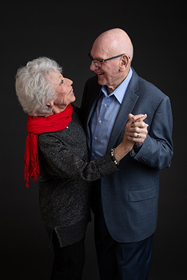 Two elderly people dancing