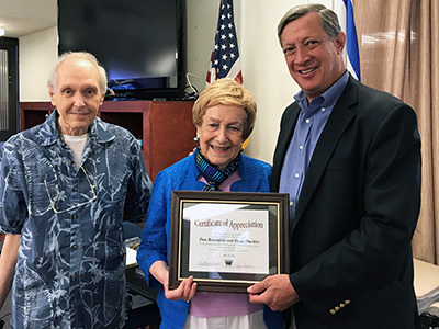 Elderly lady being awarded with a certificate