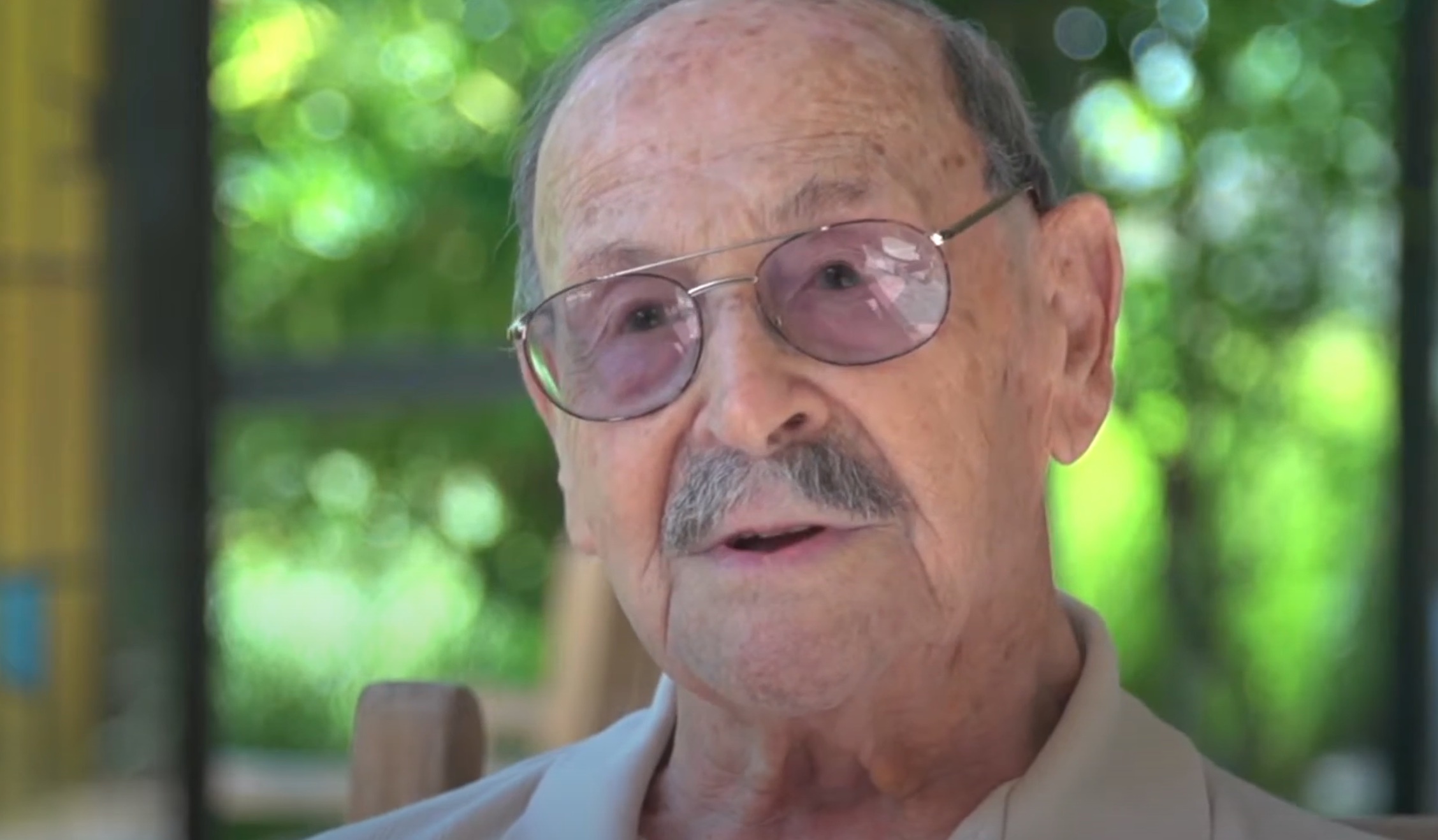 Older man with a mustache and glasses