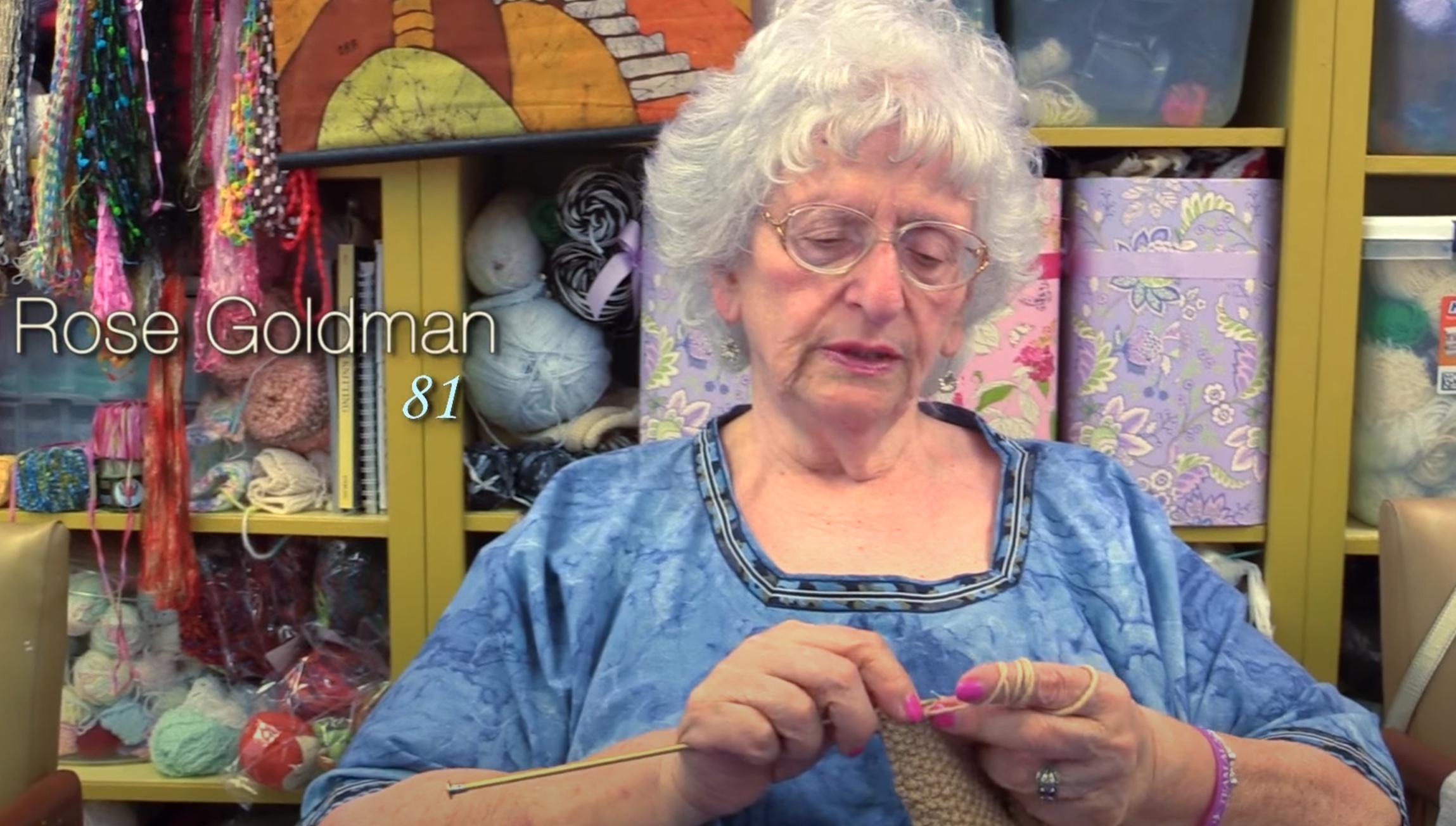 Older woman knitting a purse