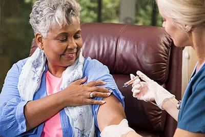 Elderly woman getting a flu shot