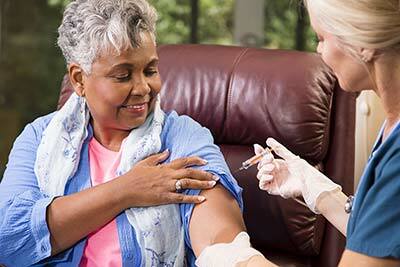 Elderly woman getting vaccinated